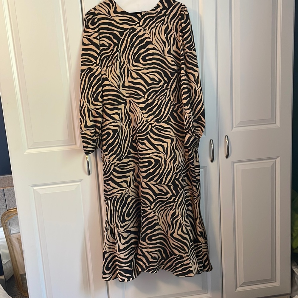Silky midi animal print dress with button cuff sleeves.